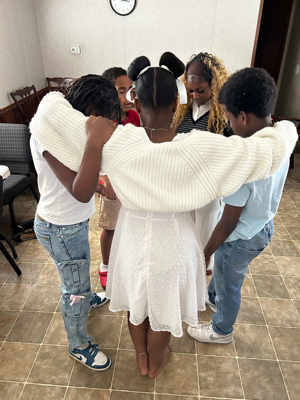 Children praying together during Children's Church at New Beginnings Ministries